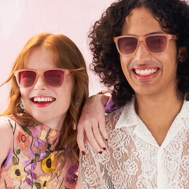 Style and fit showcase of pink square-shaped sunglasses with pink gradient lenses. Highlighting both men's and women's fit.