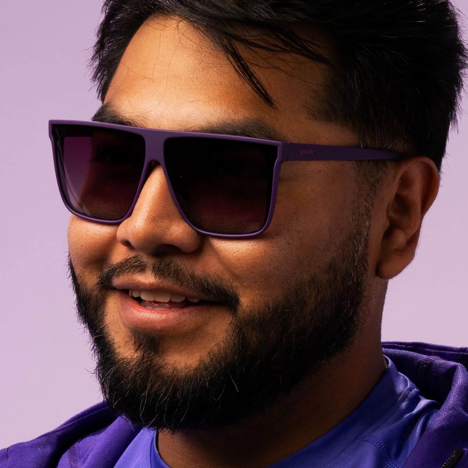 Style and fit showcase of oversized flat-top dark purple sunglasses with gradient lenses.